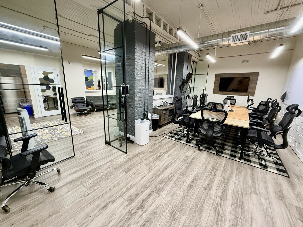 Main conference room with glass partitions and 10-seat table