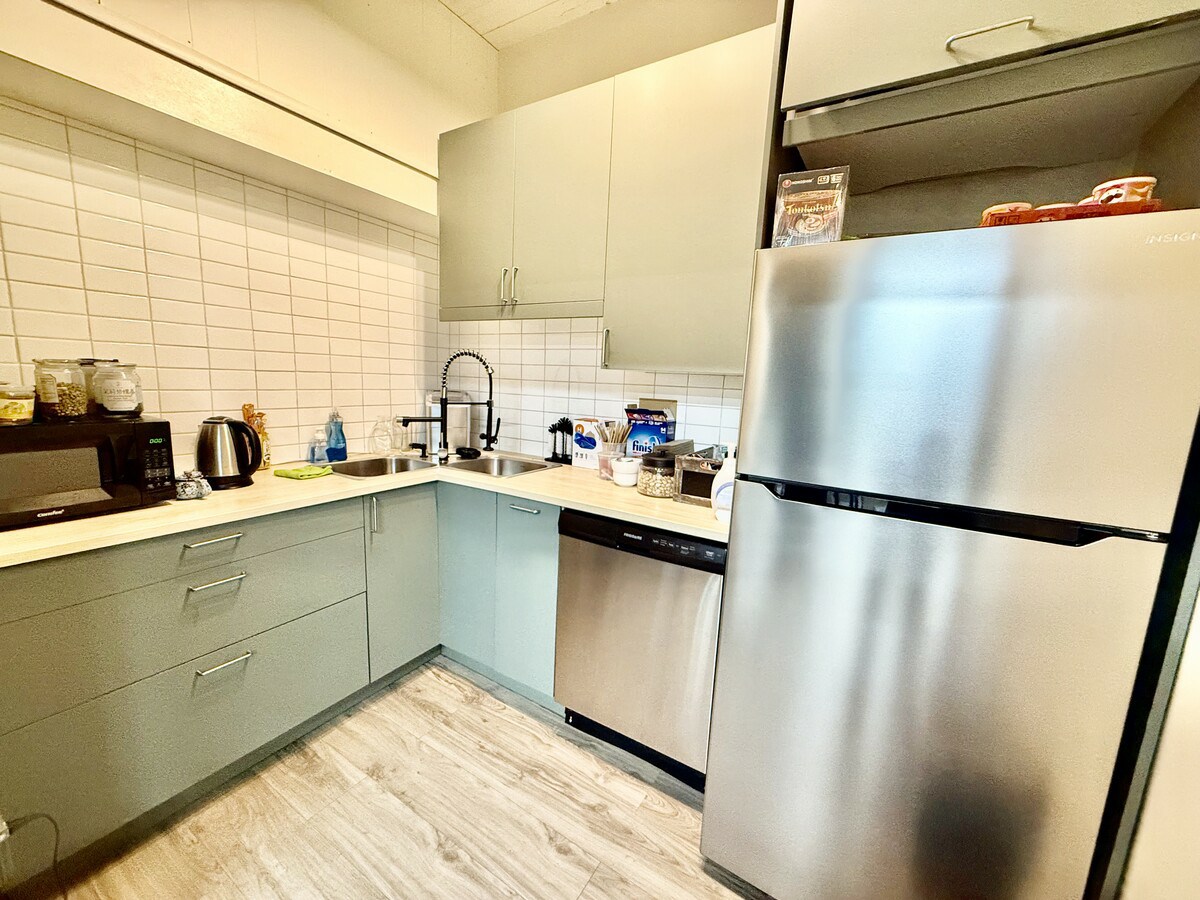 Modern kitchenette with full-size refrigerator and dishwasher